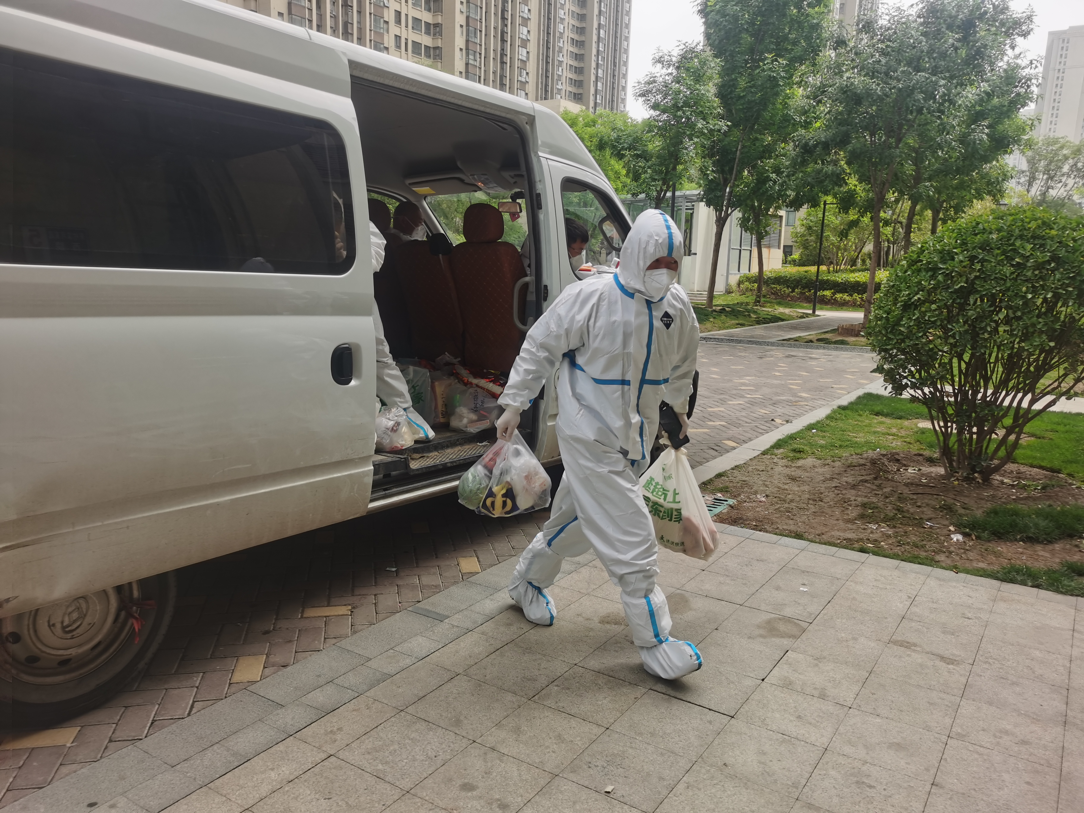 疫情防控进行时豫同心再战疫郑重启瞰复工郑州公交的大白和志愿红